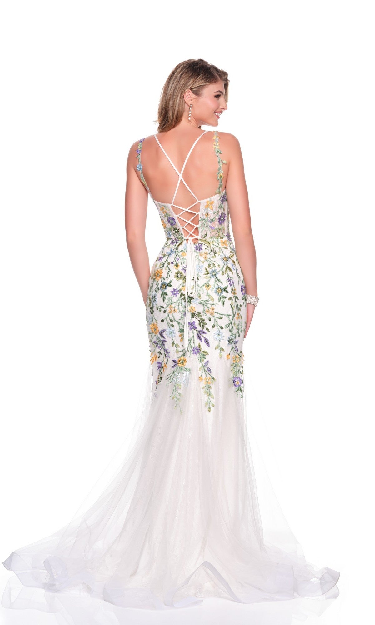 Woman wearing the Dave and Johnny 12447 long prom dress, featuring floral embroidery, a fitted bodice, lace-up back, and crisscross straps, standing and facing away.